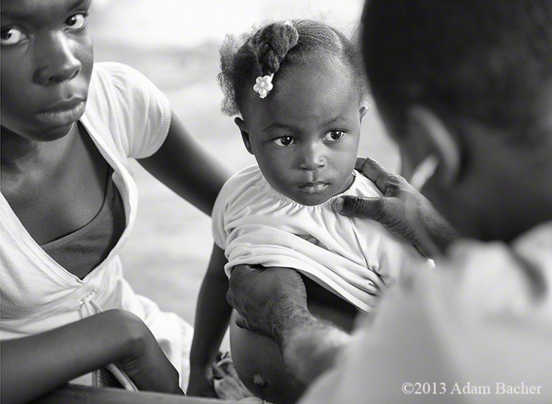 Mother and child being examined by a doctor, Dondon, Haiti, Mobile Healthcare Clinic