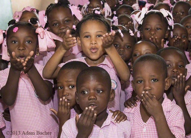 School children in Haiti blowing a kiss