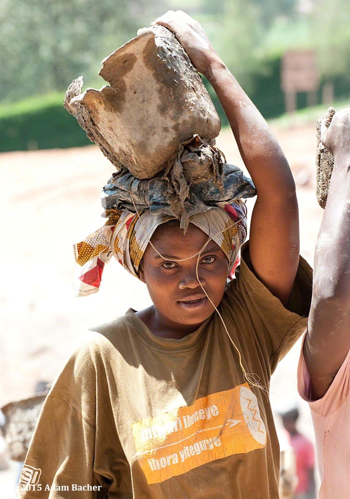 portland oregon editorial photographer - rwandan woman with bucket of cement