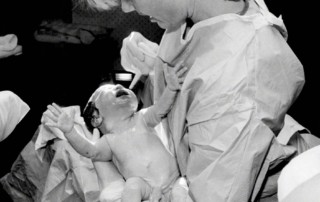 baby and umbilical cord with doctor at birth